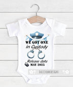 Daiichiban Designs Police Pregnancy Announcement Baby Bodysuit – “We Got One in Custody” with Custom Date